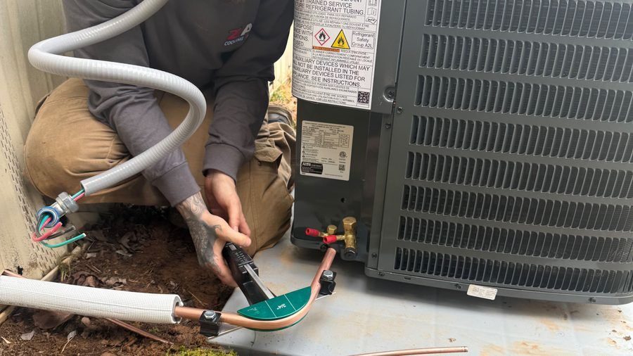 HVAC tech repairing AC unit.