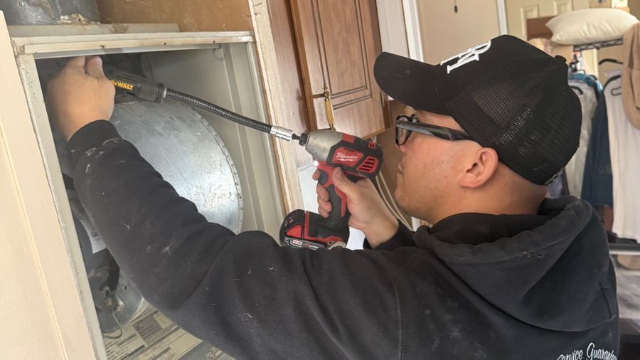 ZAP HVAC tech repairing heating system.